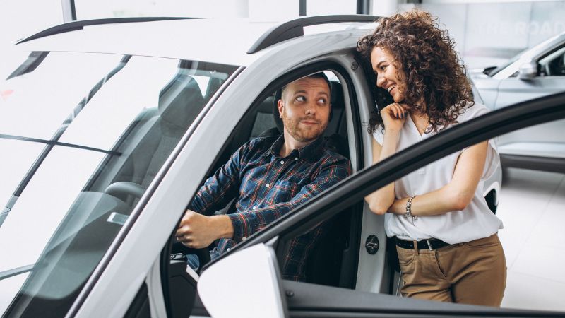 Happy family receiving car keys at a dealership